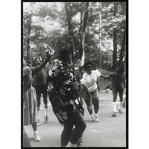 A Group of children dancing and having a good time in a wooded clearing