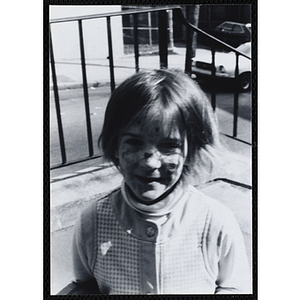 A girl with a painted face attends a party