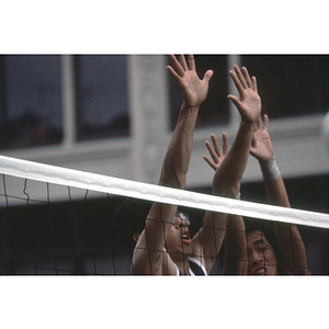 Volleyball player blocking the ball