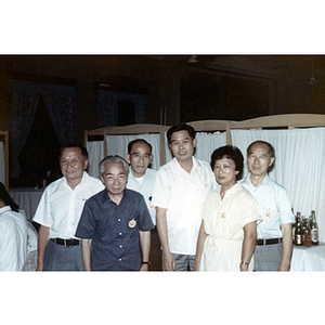 Henry Wong stands with four men and one woman during a dinner party in Guangzhou, China