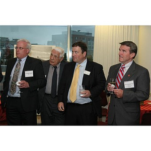 Four men listen at the Veterans Memorial dinner