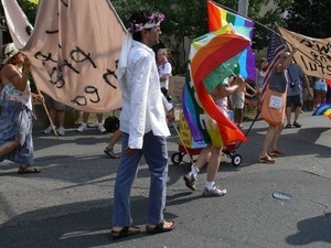Parade marchers carrying signs promoting peace : Provincetown Carnival parade