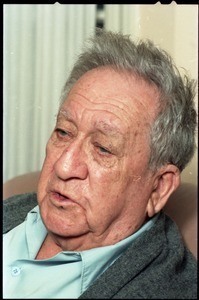 Fine art photographer Aaron Siskind: close-up portrait, while seated in a armchair in his living room