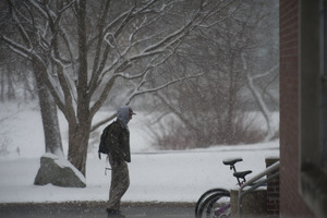 Student trudging through the snow, UMass Amherst, during his book event