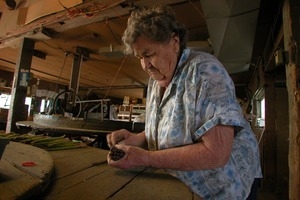 Hibbard Farm: woman at a round table, bunching asparagus