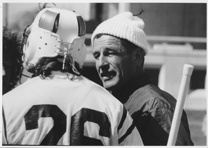 Dick Garber standing outdoors, talking with player