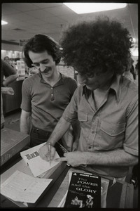 Abbie Hoffman signing a copy of Steal This Book