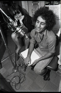 Abbie Hoffman: unidentified woman and Hoffman (right) at the microphone, WBCN studio