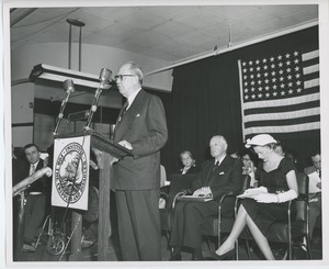 Jeremiah Milbank, Sr. speaking behind podium at Institute Day