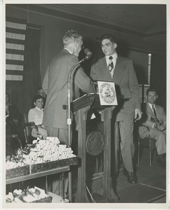 Bruce Barton shaking hands with graduate at Institute Day