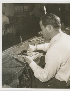 A man works on the 1955 President's Committee on Employment of the Physically Handicapped Award