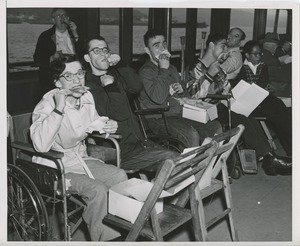 Wheelchair users eating lunch on ship