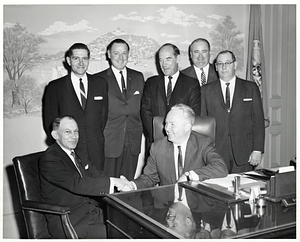 Mayor John F. Collins in his office with unidentified men