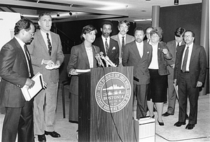 Mayor Raymond L. Flynn behind a podium with Councilors Charles Yancey, Bruce Bolling and others