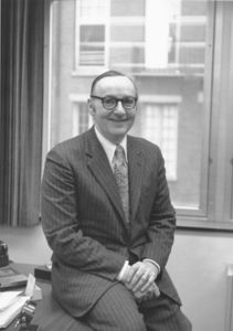 Suffolk University President Thomas A. Fulham (1970-1980), seated on desk
