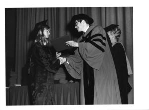 Student receiving her diploma from Dean Donald Grunewald at the 1970 Suffolk University commencement