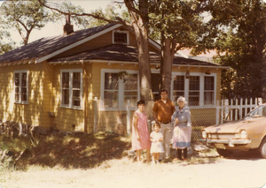 The Rose family in front of their home, before they renovated it!