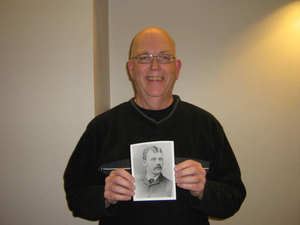 James Halpin holding a photograph of his grandfather John Joseph Halpin