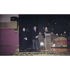 David Cortiella, Mayor Menino, and an unidentified man on stage during a Three Kings Day celebration at the Jorge Hernandez Cultural Center.