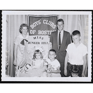 Miss Bunker Hill, the winner of the Boys' Club Little Sister Contest, sits on her throne while her brother and two judges pose, including Richard Harte, Jr., at right