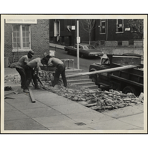 Three men working with a jackhammer and shovel during the Boys' Clubs of Boston Charlestown Clubhouse renovation at 15 Green Street