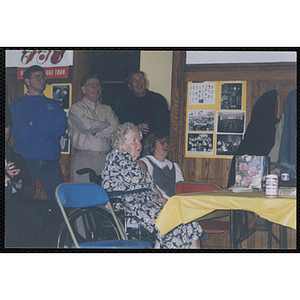 Two women sit at a table during a Bunker Hillbilly alumni reunion event