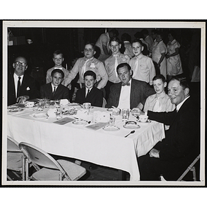 A group of boys pose with three men at a Dad's Club event