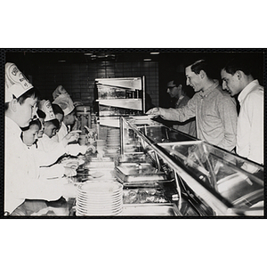 Members of the Tom Pappas Chefs' Club serve diners in a Brandeis University dining hall