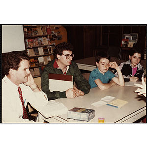 Group of people sitting at a table during an open house