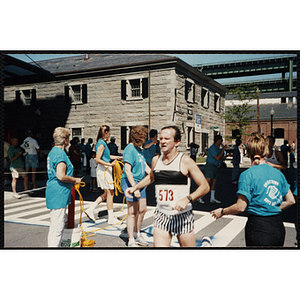 A man passes the finish line during the Battle of Bunker Hill Road Race