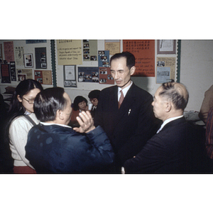 Henry Wong and two other members of the Chinese Progressive Association speak to a visiting Chinese diplomat at the organization's Boston office