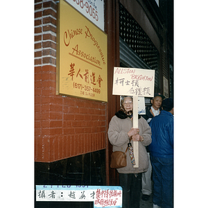 Woman in front of the Chinese Progressive Association building on Immigrant Labor Day