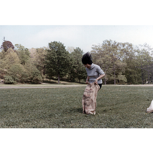 Suzanne Lee competes in a sack race during a tutoring class picnic