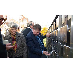 People look at plaques on the Veterans Memorial at the dedication ceremony