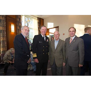 Mark Fitzgerald and Joseph Aoun pose with two men at the Veterans Memorial dedication ceremony