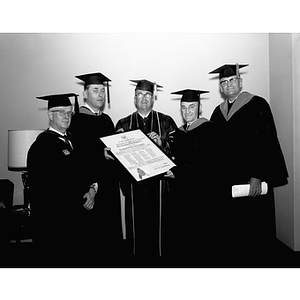 Five men hold a plaque as they found a chapter of the Society of the Sigma Xi, a scientific honor society