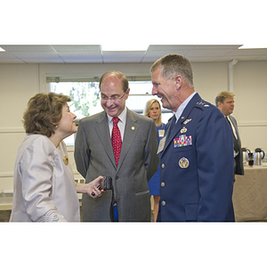 Lieutenant General Ted F. Bowlds, right, and President Joseph E. Aoun, center, speak to a woman during the groundbreaking ceremony for the George J. Kostas Research Institute for Homeland Security, located on the Burlington campus of Northeastern University