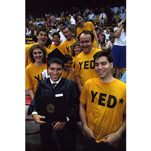 Graduate holding his diploma at the 1994 commencement ceremony