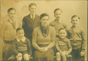 Group studio portrait of an unidentified woman and six boys, 1930s