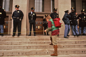 Woman weaves a yellow ribbon across the steps of the Pentagon