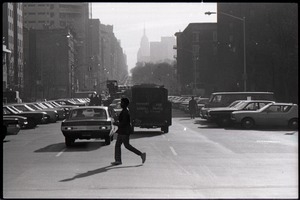 Man crossing a busy street in New York City