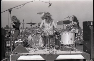 Hollywood Speedway Rock Festival: Jo Jo Gunne in performance, view from behind drummer (Curly Smith), with keyboards (Jay Ferguson) and bassist (Jimmy Randall)