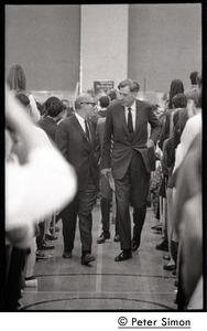 John Kenneth Galbraith (center right) walking up the aisle before introducing speech by presidential candidate Eugene McCarthy at Boston University