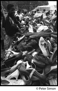 Resurrection City: young boy looks over a pile of shoes