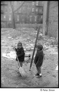Two young boys playing in an empty lot