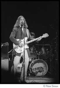 T-Bone Burnett playing Rickenbacker guitar on stage at the Harvard Square Theater, Cambridge, with the Rolling Thunder Revue