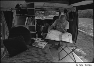 Ram Dass in his van: Ram Dass studying a map