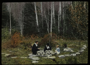 Two woman and child sitting around well (?) by birch forest