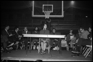Helen Sullinger (student, UMass Amherst) makes a statement of students' viewpoint at open meeting with school administration, Curry Hicks Cage, regarding protests against war in Vietnam