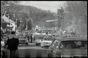 Convoy of cars in Highland Falls, N.Y., bringing home the hostages from Iran, welcome signs in the distance